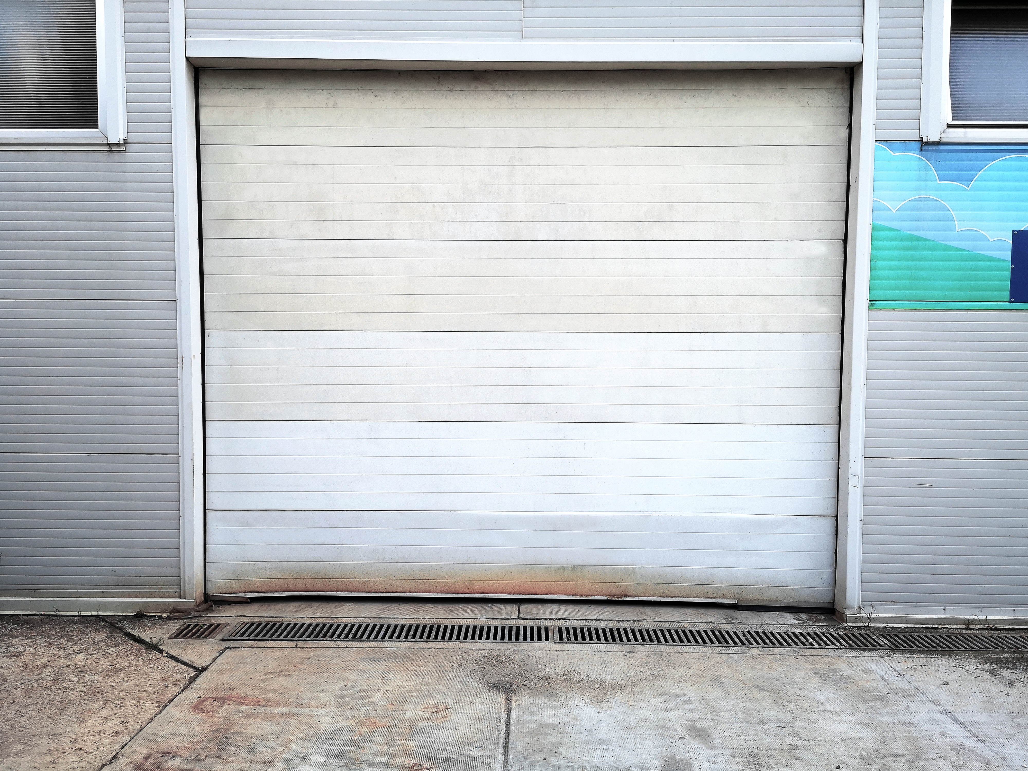 Damaged garage door section being removed