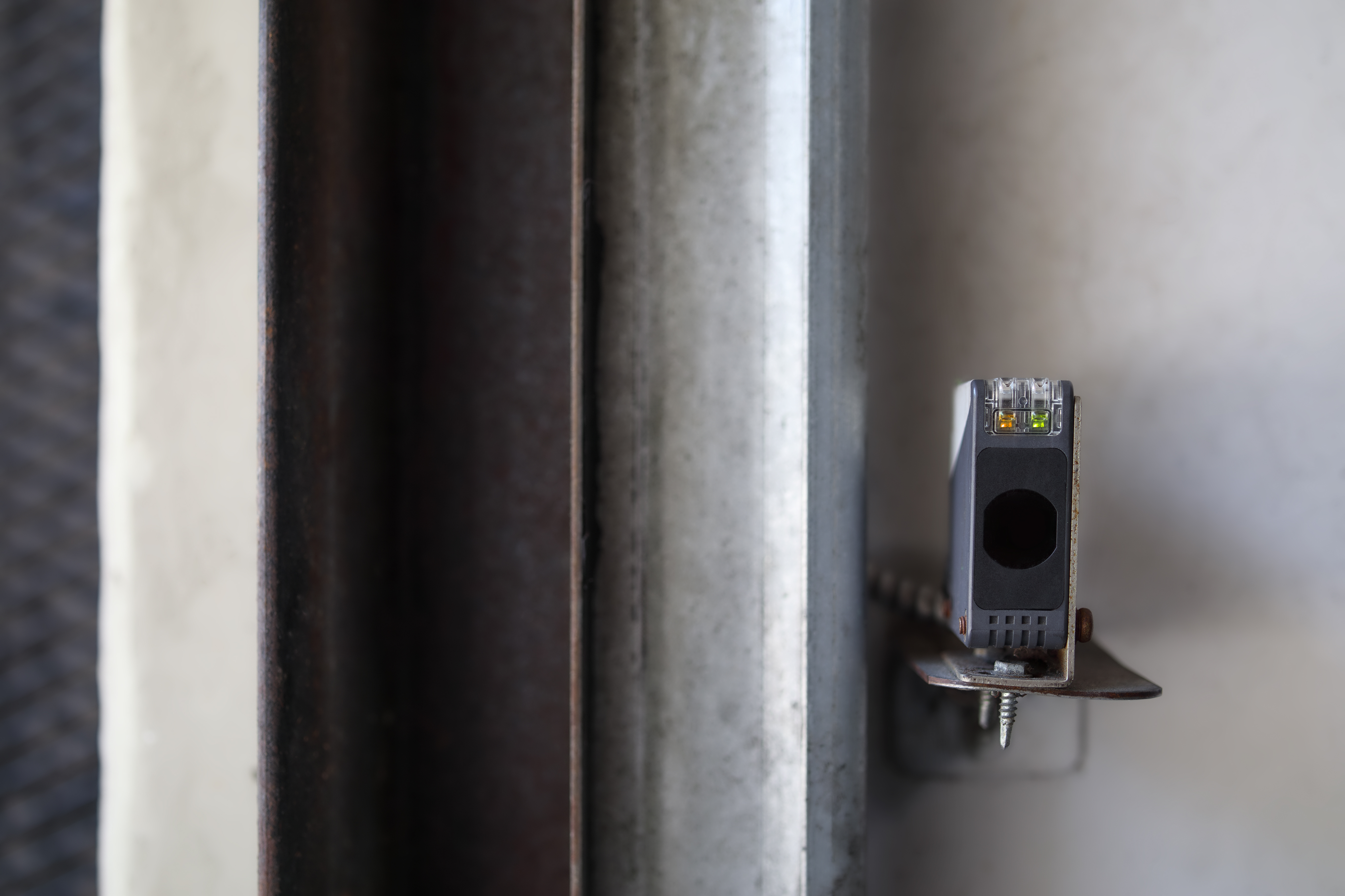 Photo-eye sensor aligned at the base of the track